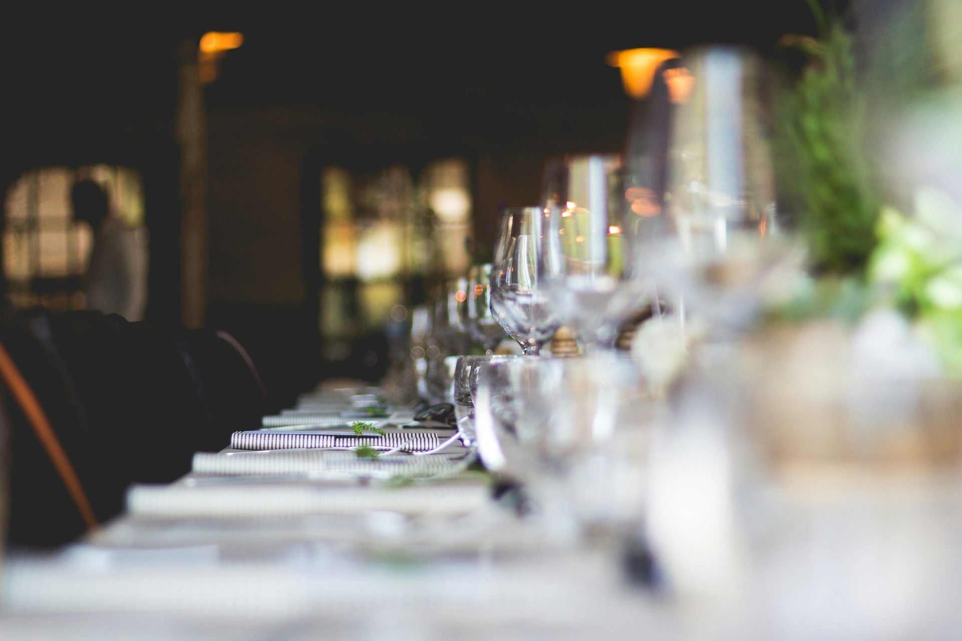 focused photo of wine glasses lined on table