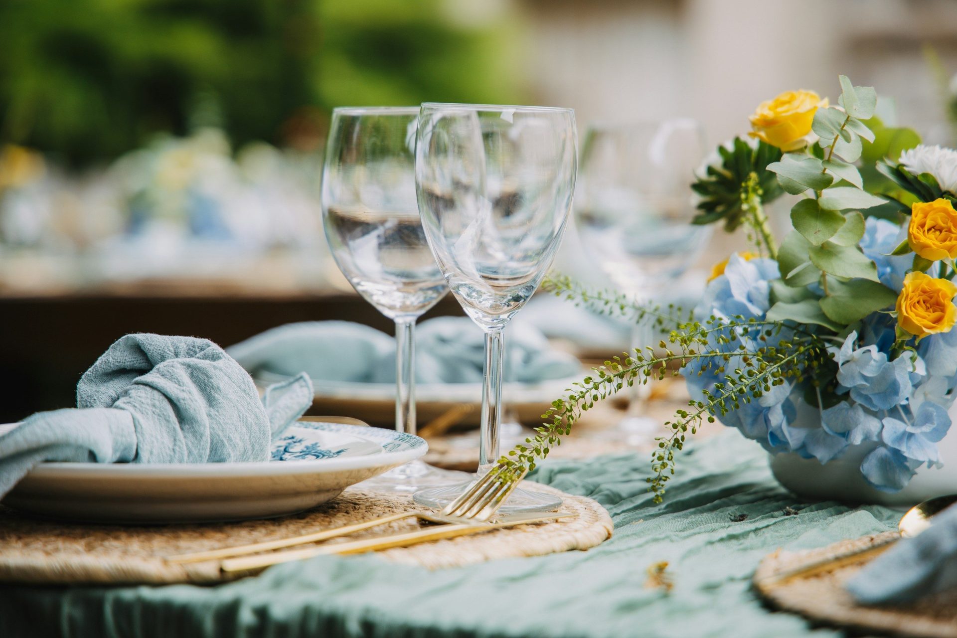 Table setting with floral arrangement and wine glasses